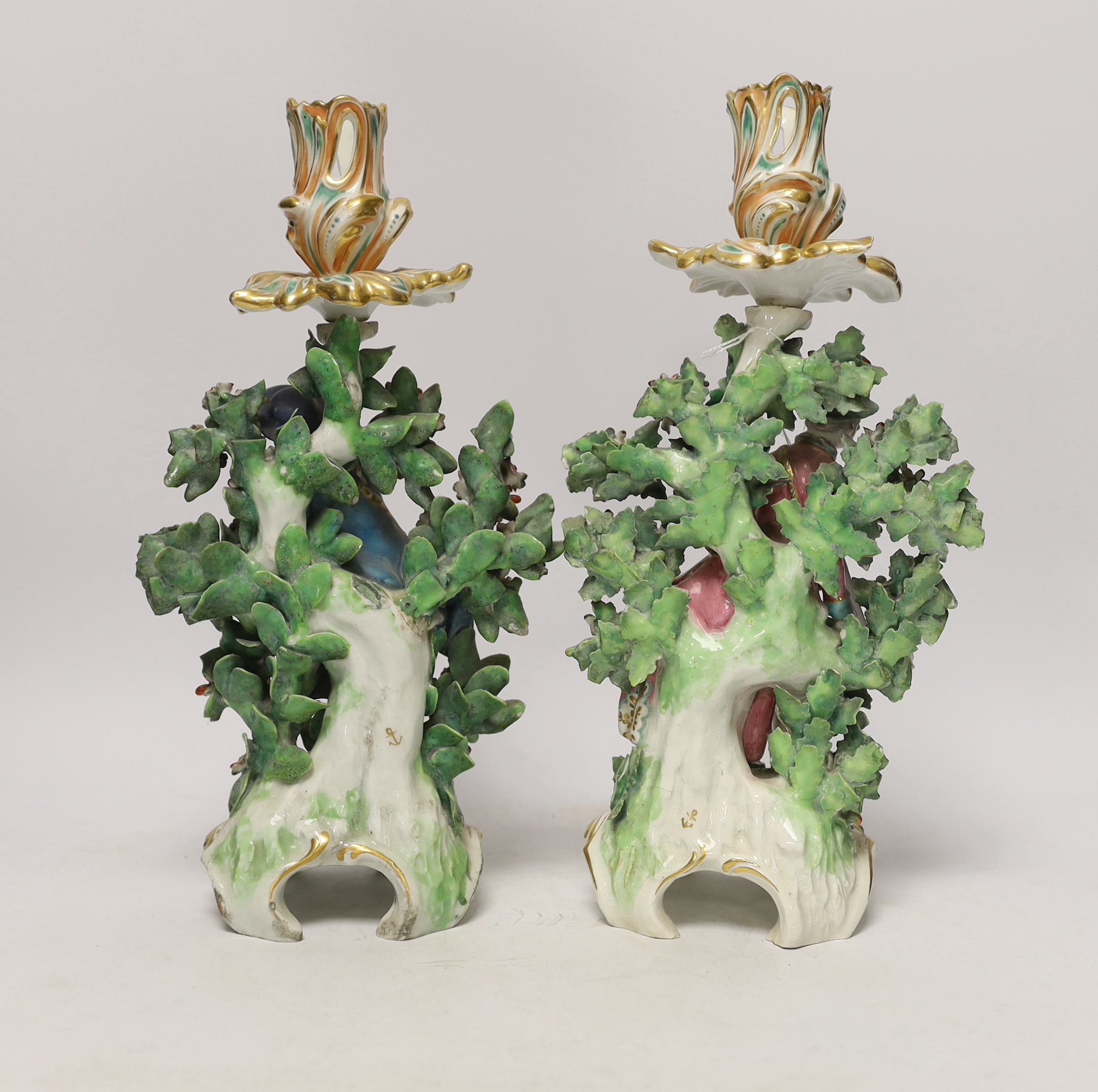 A pair of Chelsea figural candlesticks, c.1765, 30cm